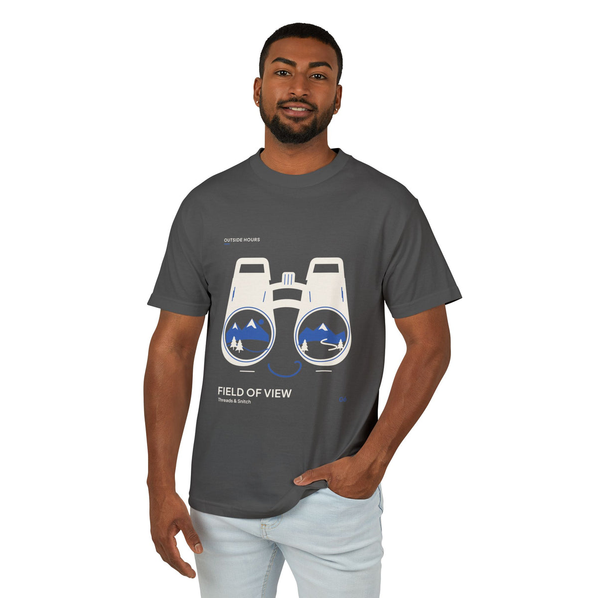 Model mockup of Field of View Binoculars Tee in Faded Black, front view showing binoculars with mountain and river landscapes inside the lenses.
