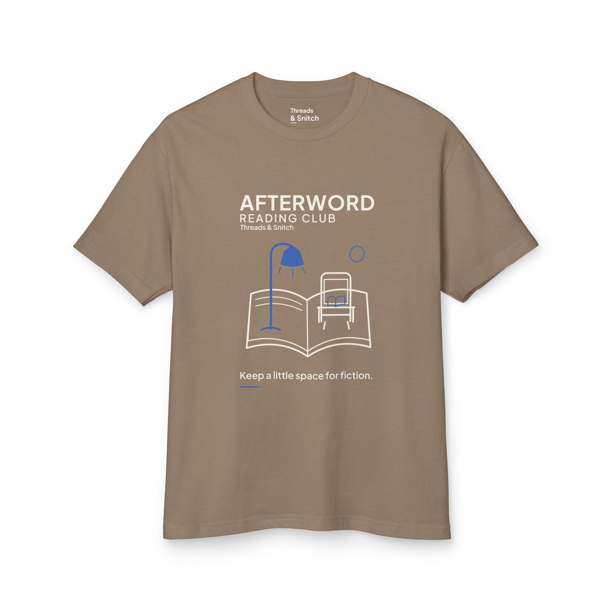 Mockup of Afterword Reading Room Tee in Faded Brown, front view showing open book forming a room with an armchair and blue lamp.
