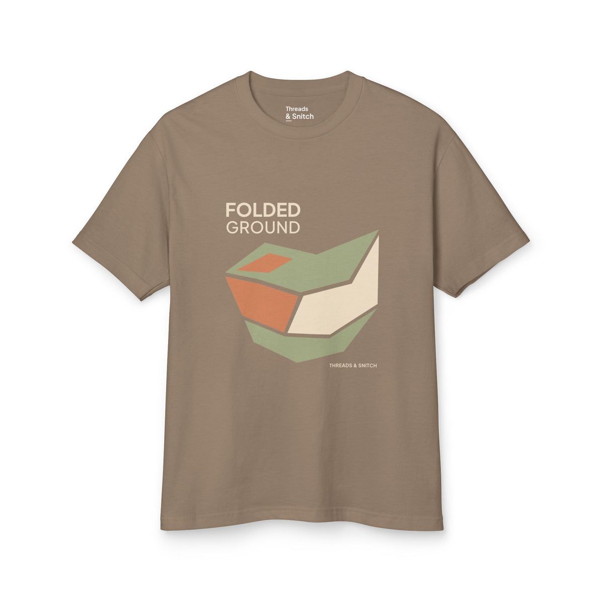 Mockup of Folded Ground Geometric Graphic Tee in Faded Brown, front view showing angular folded planes with open channels and Folded Ground lettering.