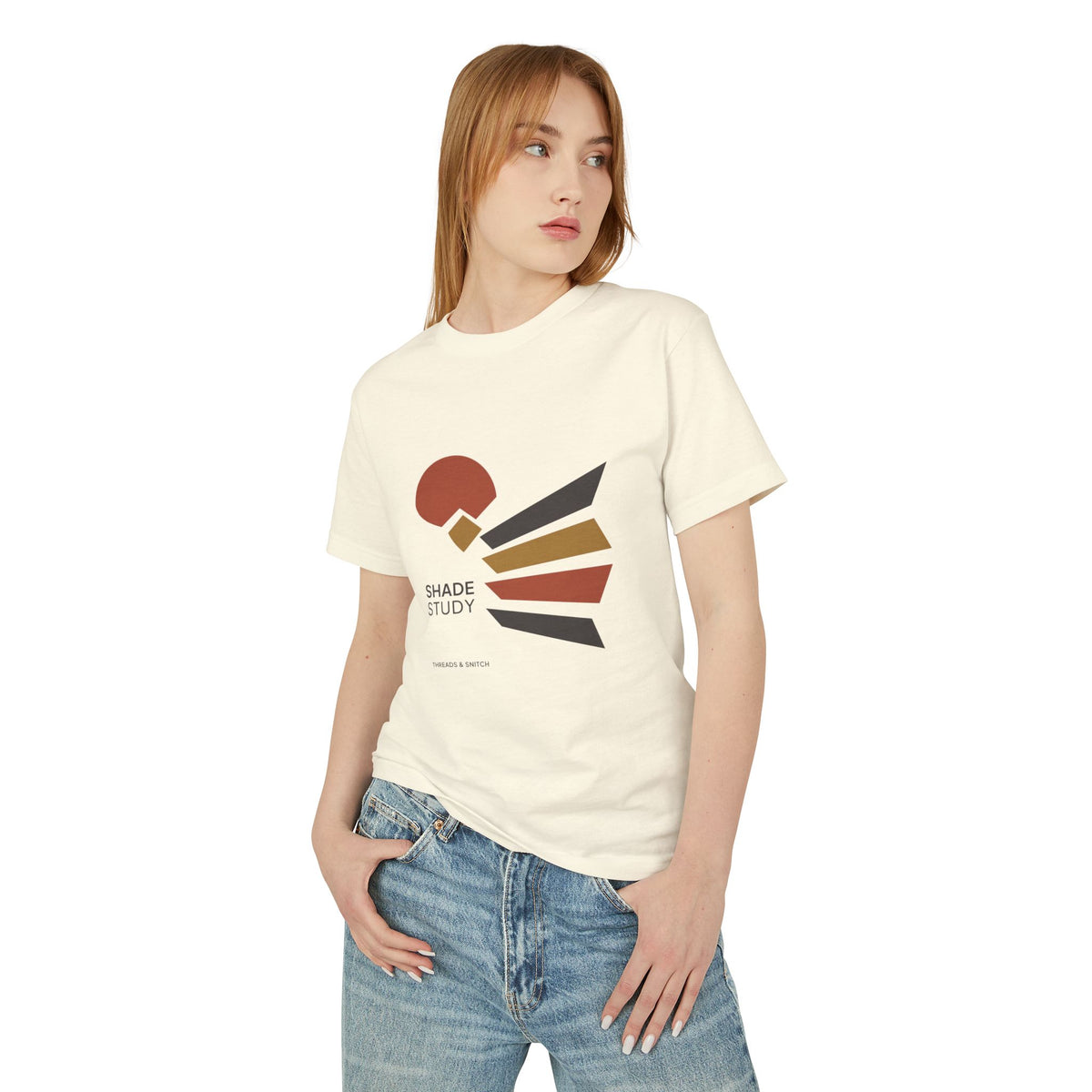 Model mockup of Shade Study Geometric Graphic Tee in Faded Cream, front view showing a cut circular shape and radiating angular planes with Shade Study lettering.