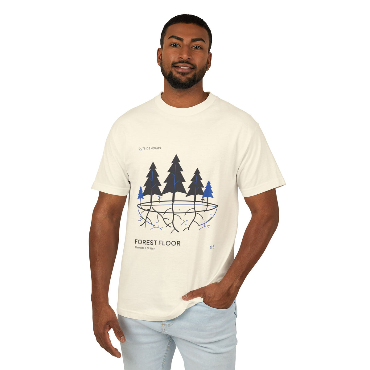 Model mockup of Forest Floor Botanical Tee in Faded Cream, front view showing five trees above exposed roots and a blue underground network.