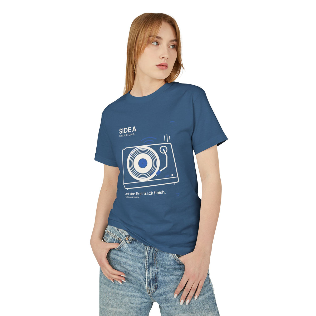 Model mockup of Side A Record Player Tee in Faded Navy, front view showing record player with open circular grooves, tonearm and blue sound marks.