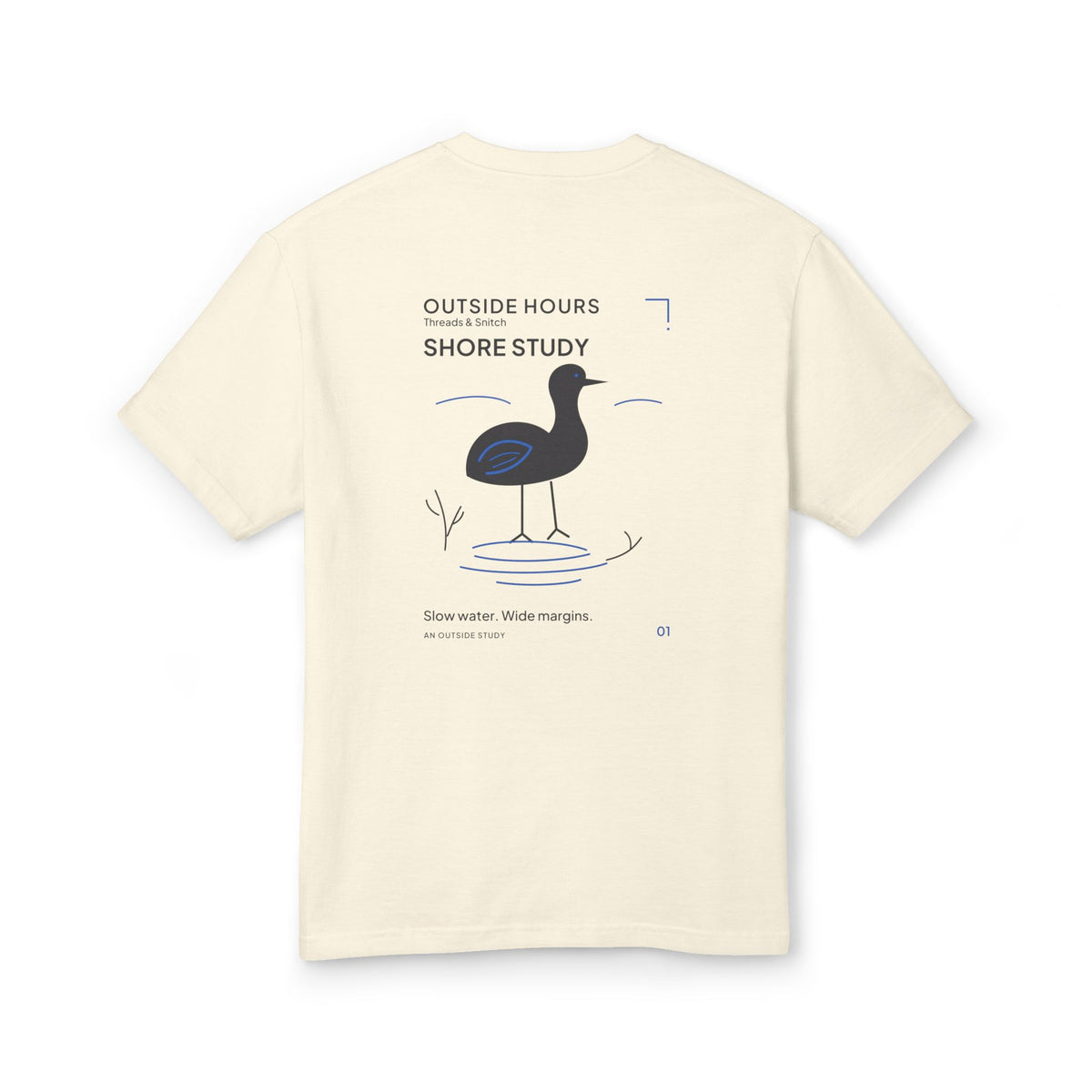 Mockup of Shore Study Bird Graphic Tee in Faded Cream, back view showing wading bird, reeds and blue water ripples.