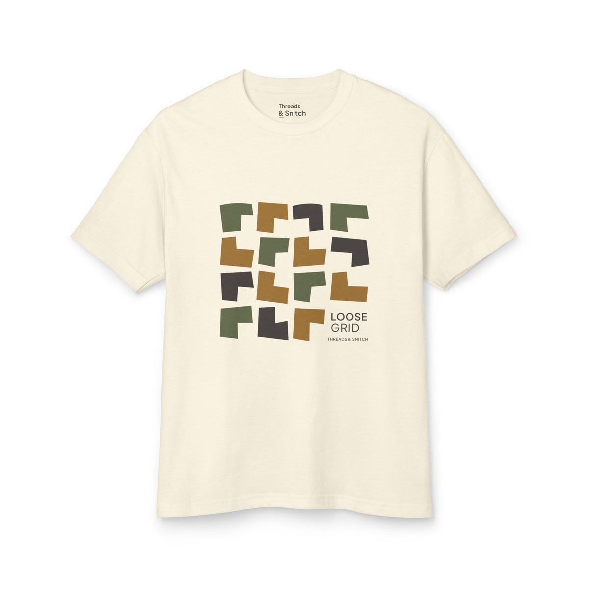Mockup of Loose Grid Pattern Graphic Tee in Faded Cream, front view showing an irregular grid of open-cut geometric tiles with Loose Grid lettering.