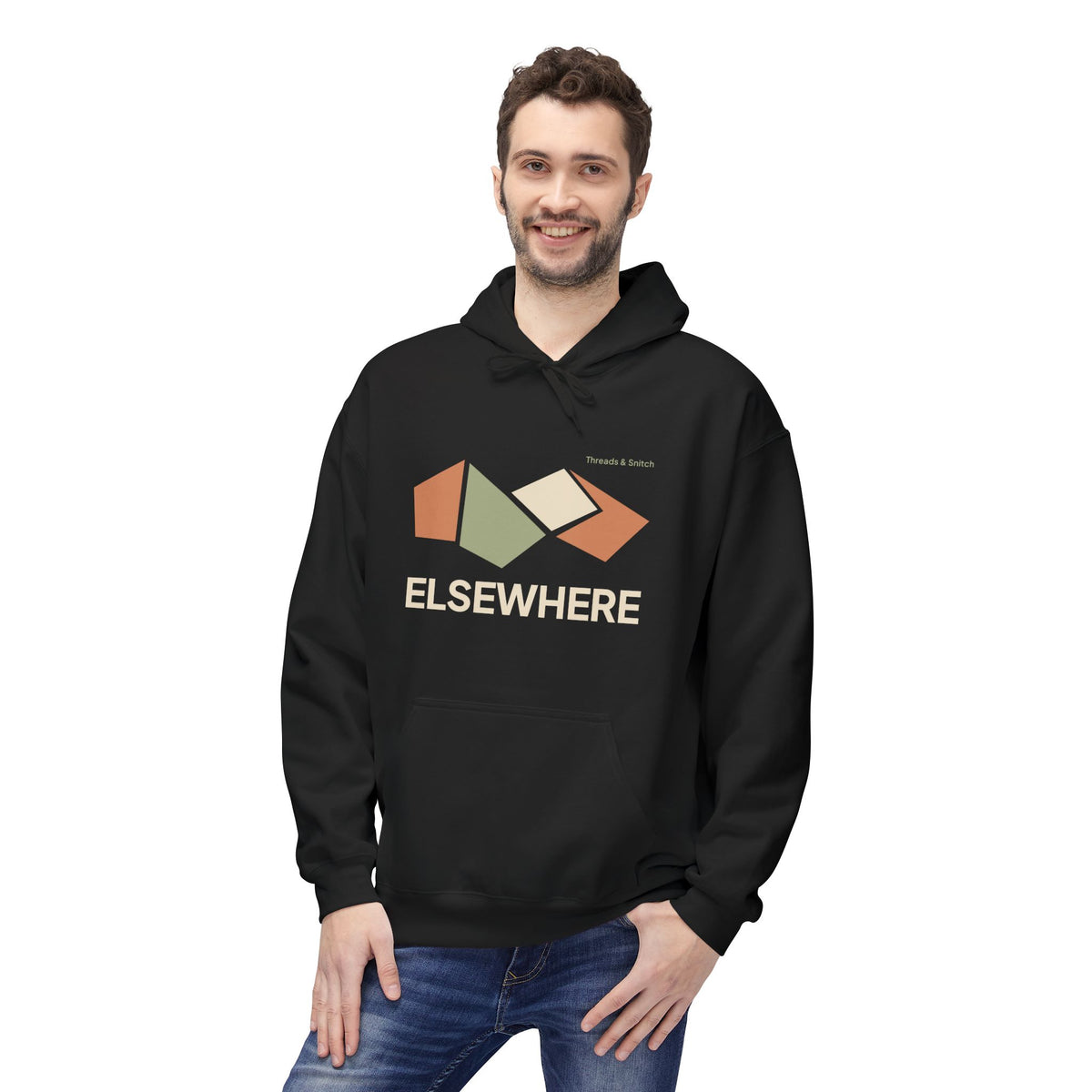 Model mockup of Elsewhere Folded Form Graphic Hoodie in Black, front view showing four folded paper-like panels above Elsewhere lettering.