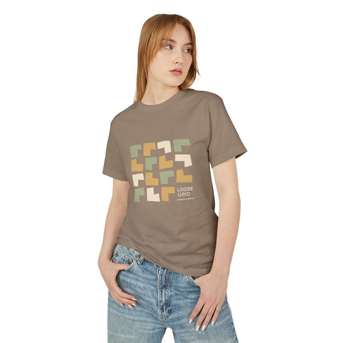 Model mockup of Loose Grid Pattern Graphic Tee in Faded Brown, front view showing an irregular grid of open-cut geometric tiles with Loose Grid lettering.