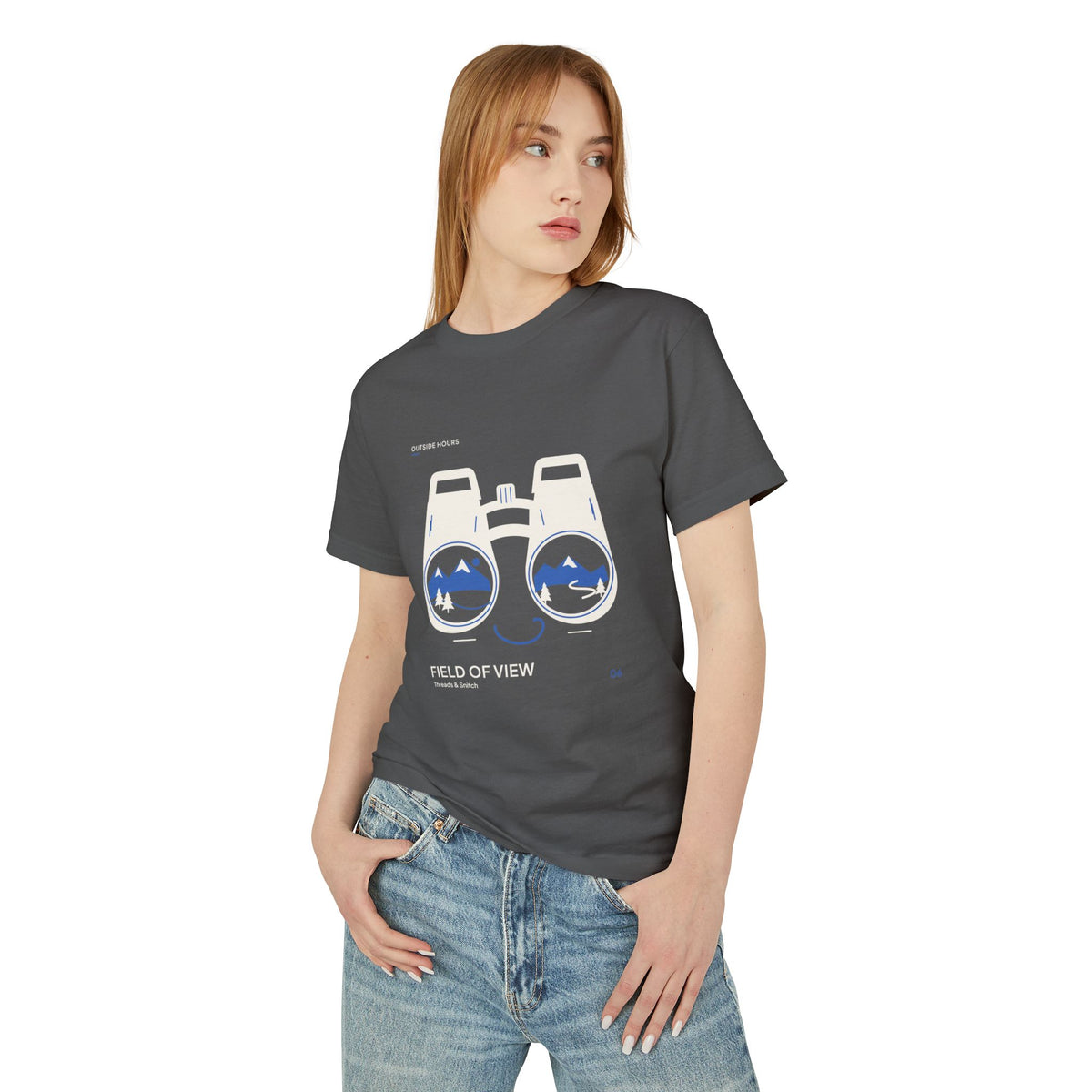 Model mockup of Field of View Binoculars Tee in Faded Black, front view showing binoculars with mountain and river landscapes inside the lenses.