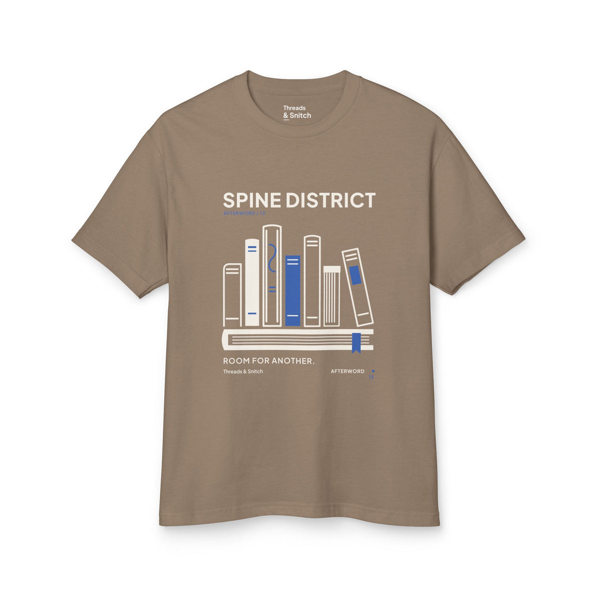 Mockup of Spine District Book Spine Tee in Faded Brown, front view showing varied book spines arranged as a skyline above a horizontal book.
