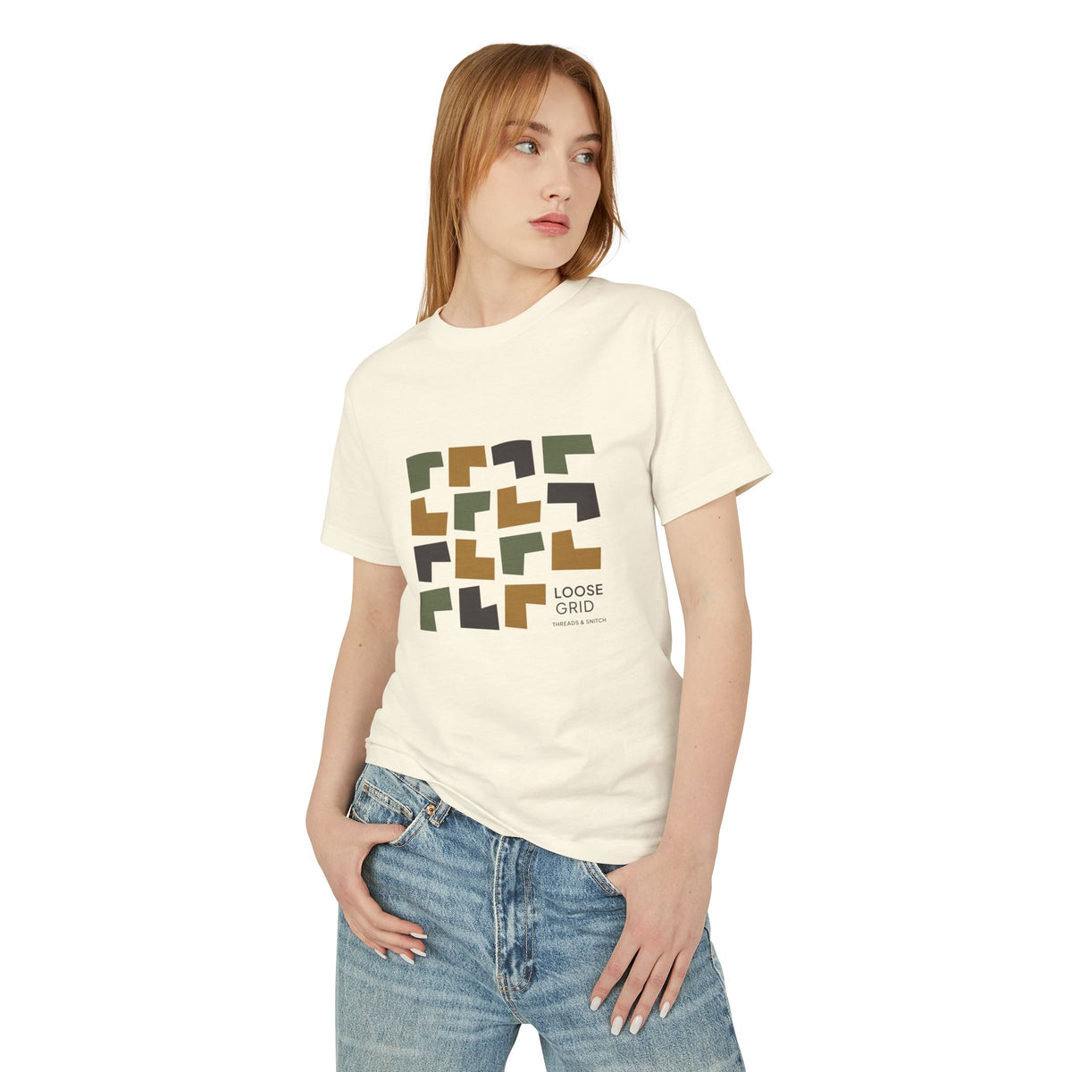 Model mockup of Loose Grid Pattern Graphic Tee in Faded Cream, front view showing an irregular grid of open-cut geometric tiles with Loose Grid lettering.