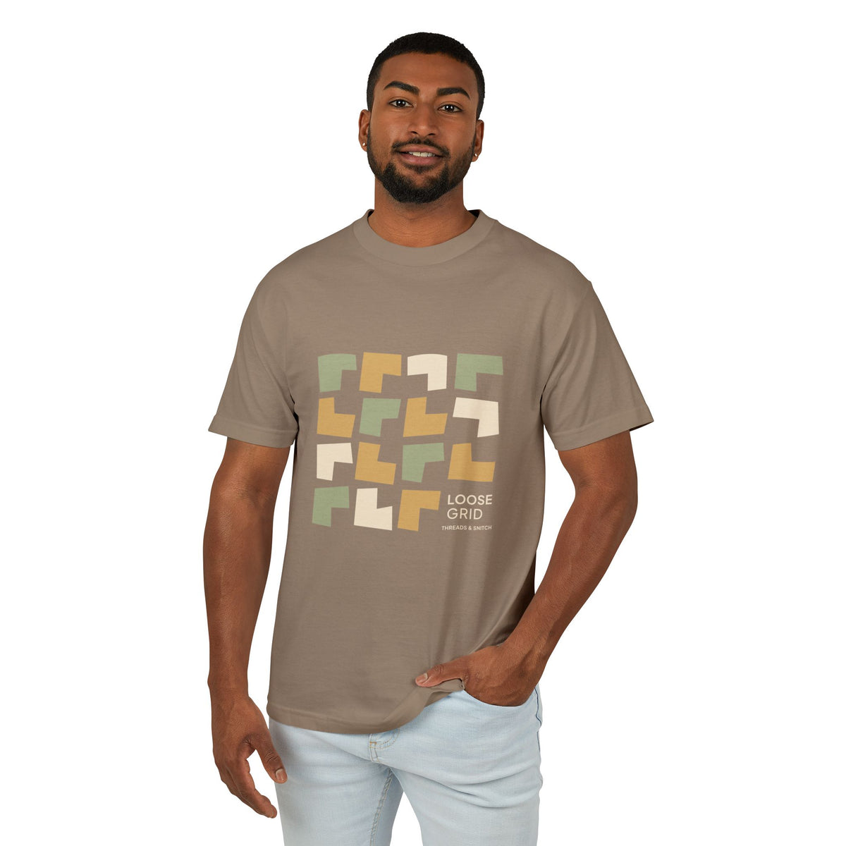 Model mockup of Loose Grid Pattern Graphic Tee in Faded Brown, front view showing an irregular grid of open-cut geometric tiles with Loose Grid lettering.