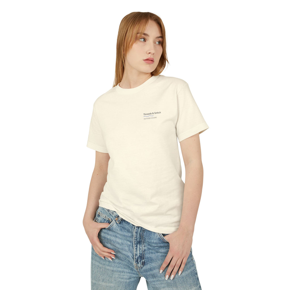 Front-view model mockup of Shore Study Bird Graphic Tee in Faded Cream, showing the small left-chest signature.