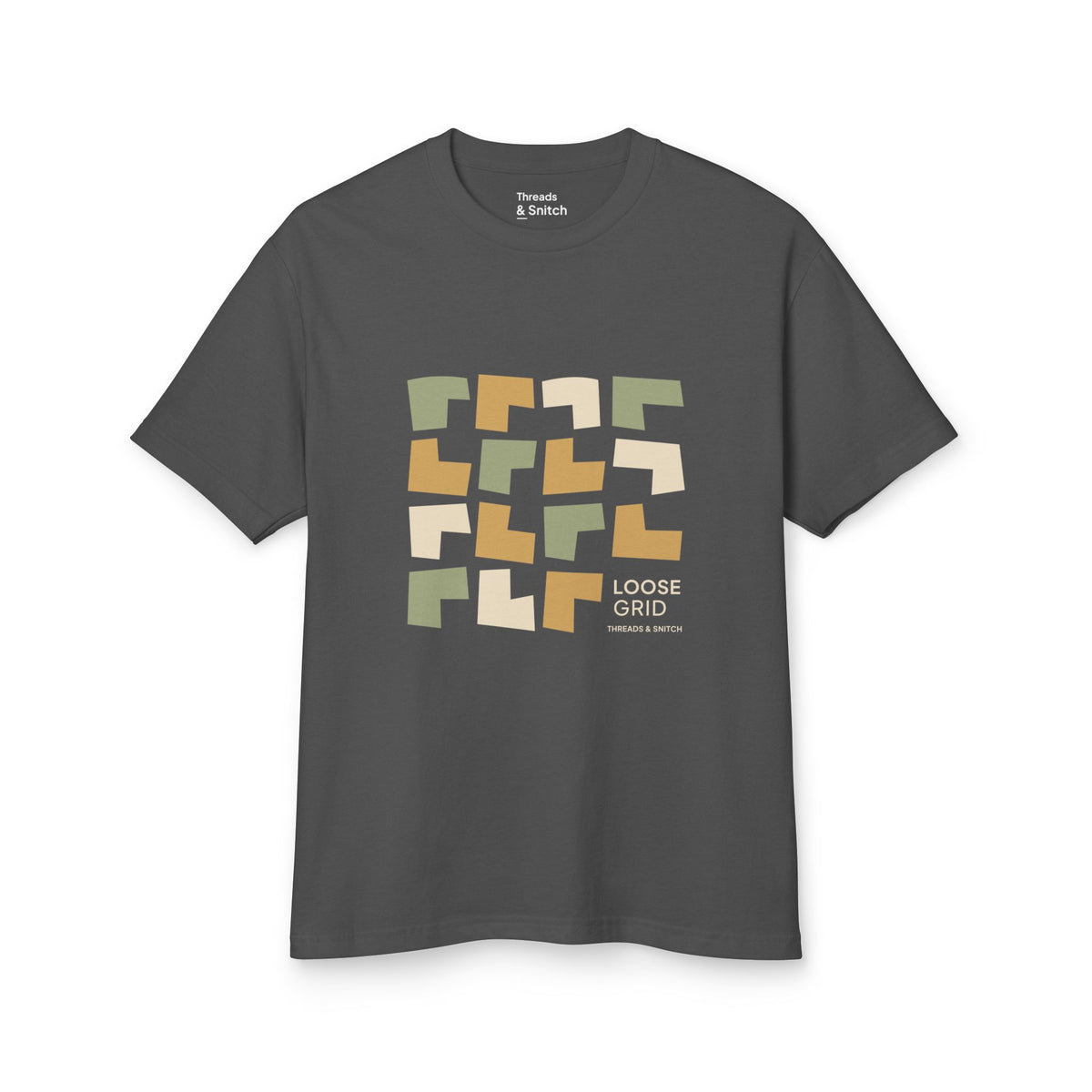Mockup of Loose Grid Pattern Graphic Tee in Faded Black, front view showing an irregular grid of open-cut geometric tiles with Loose Grid lettering.