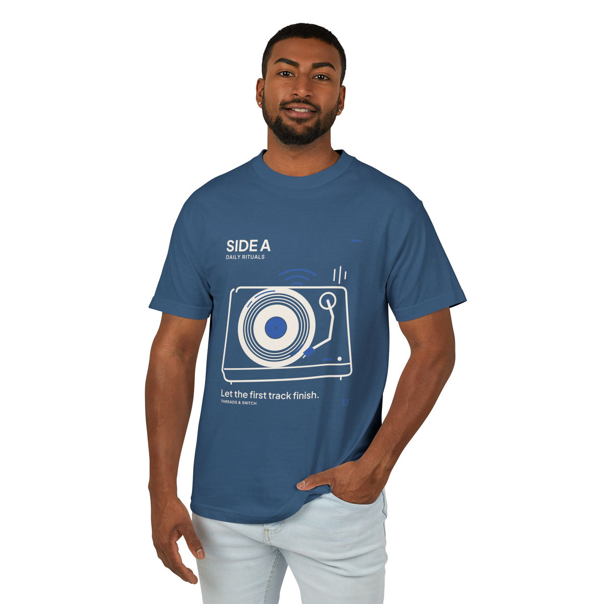 Model mockup of Side A Record Player Tee in Faded Navy, front view showing record player with open circular grooves, tonearm and blue sound marks.