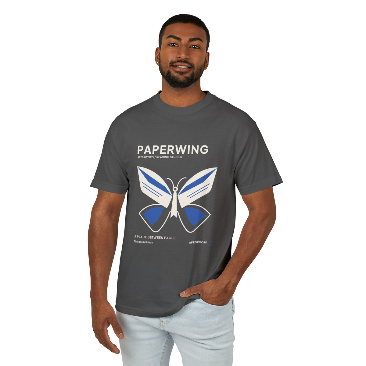 Model mockup of Paperwing Bookish Moth Tee in Faded Black, front view showing moth formed from folded-paper wings and a bookmark-like body.