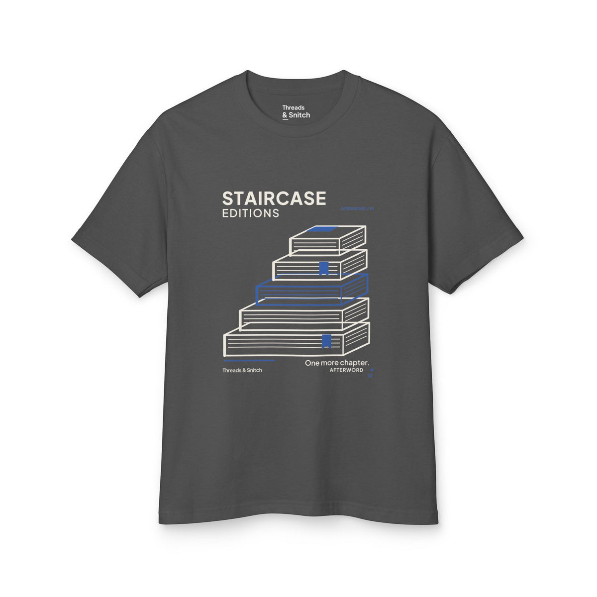 Mockup of Staircase Editions Book Stack Tee in Faded Black, front view showing five staggered books forming stairs with blue bookmarks.