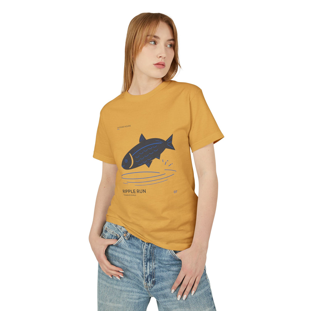 Model mockup of Ripple Run Fish Graphic Tee in Faded Mustard, front view showing fish above wide blue water ripples.