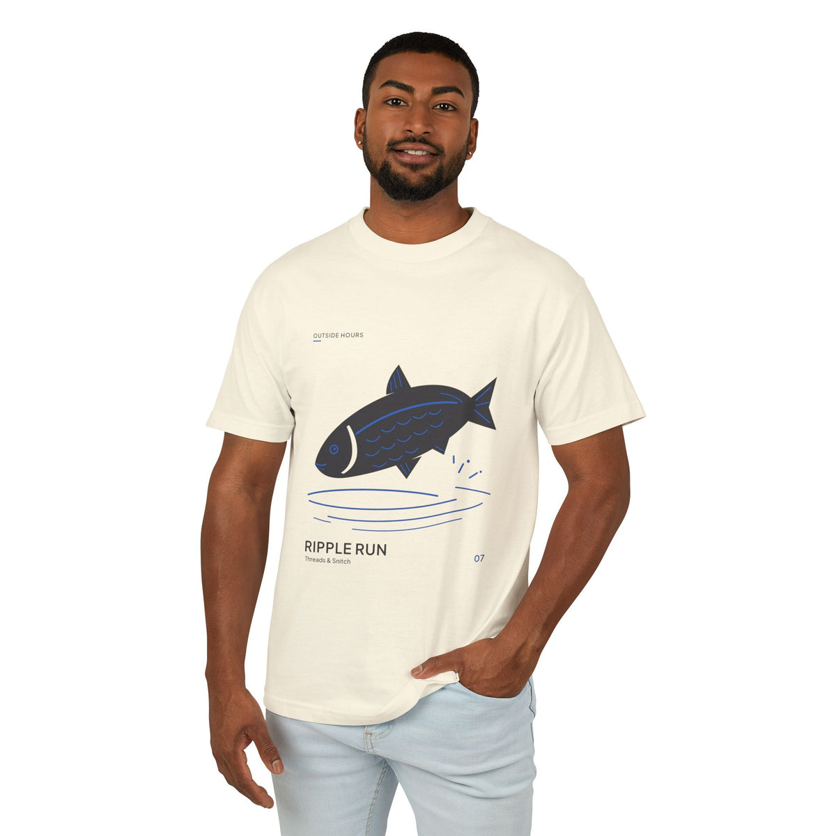 Model mockup of Ripple Run Fish Graphic Tee in Faded Cream, front view showing fish above wide blue water ripples.