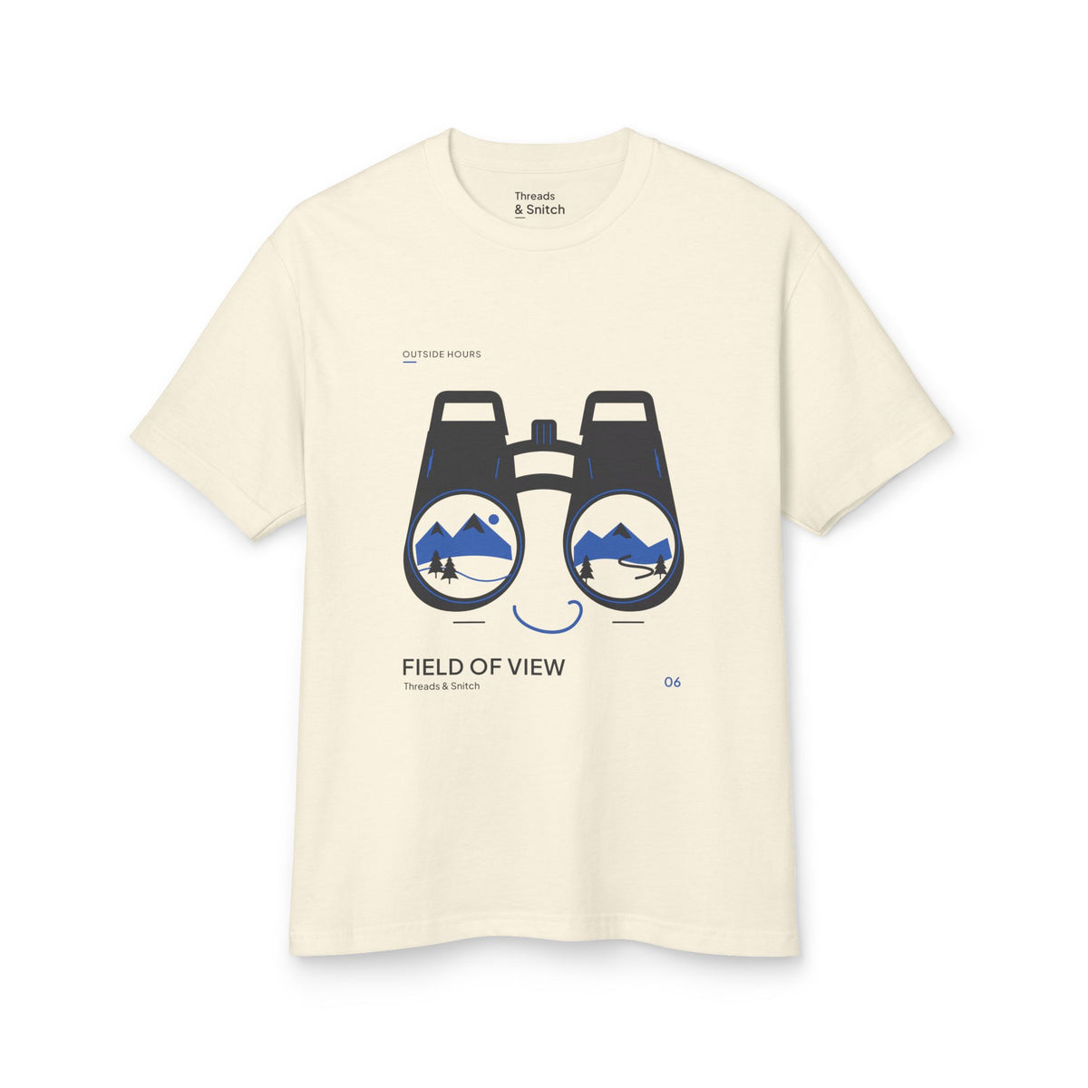 Mockup of Field of View Binoculars Tee in Faded Cream, front view showing binoculars with mountain and river landscapes inside the lenses.