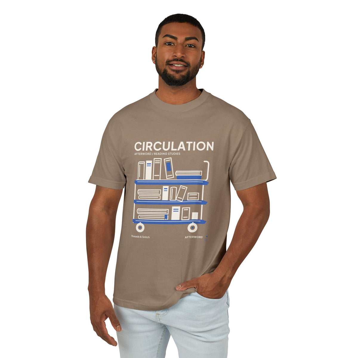 Model mockup of Circulation Library Cart Tee in Faded Brown, front view showing three-tier library cart filled with books and blue shelves.