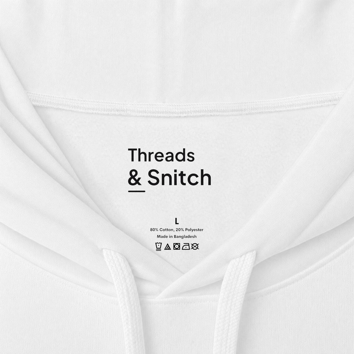Mockup detail of the printed Threads & Snitch inner-neck label on Gather Ribbon Graphic Hoodie in White.