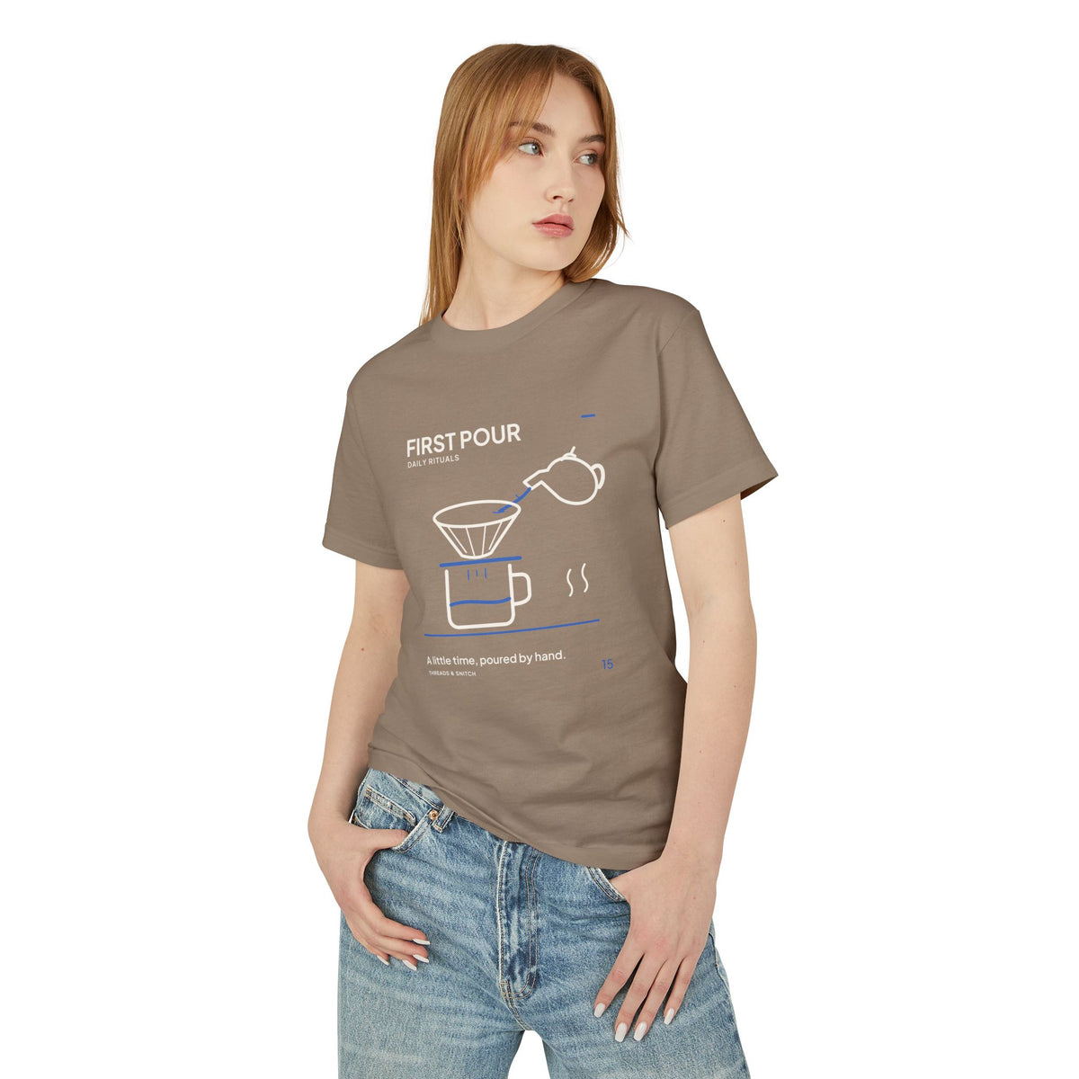 Model mockup of First Pour Coffee Graphic Tee in Faded Brown, front view showing kettle pouring blue water into a coffee filter above a brew pot.