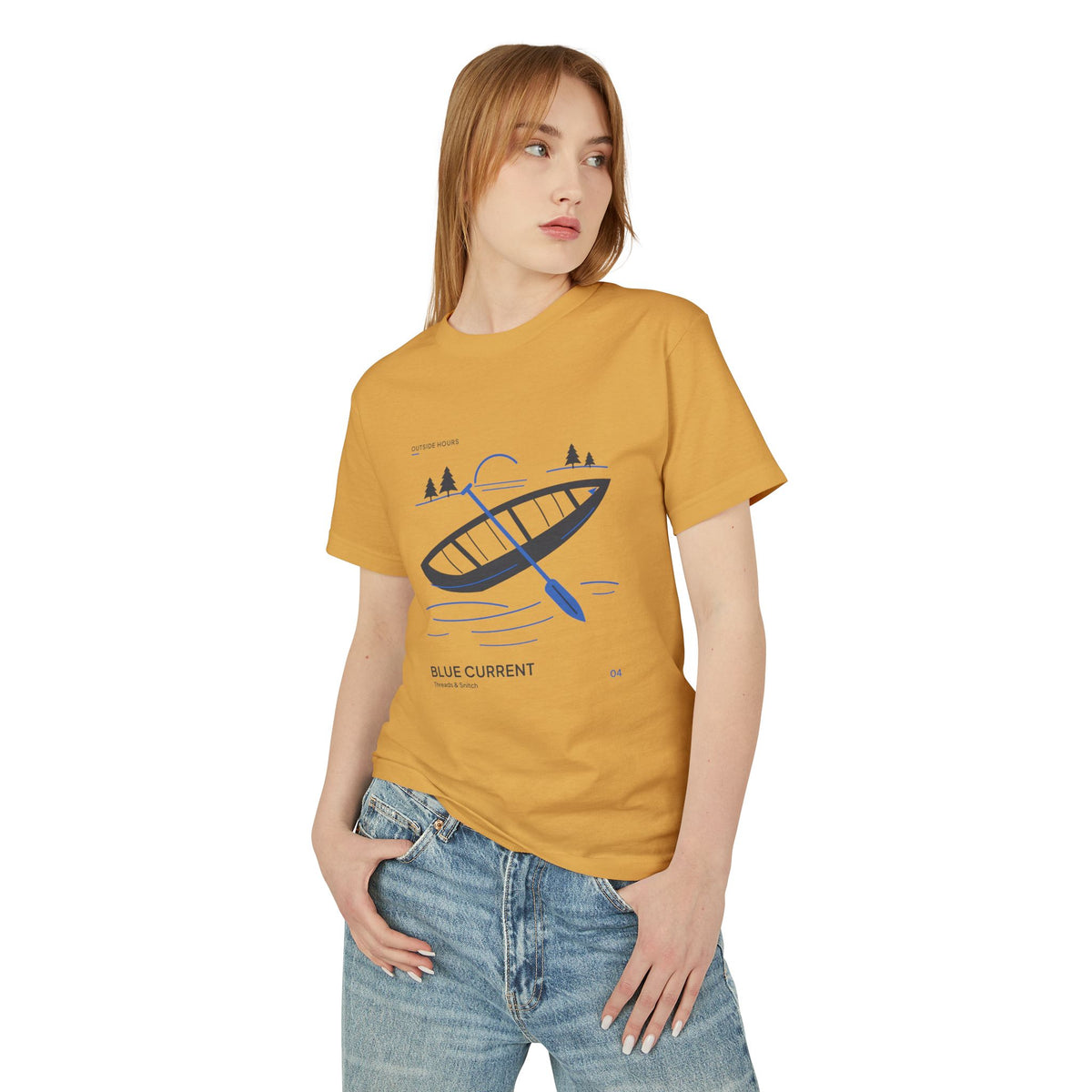 Front-view model mockup of Blue Current Canoe Graphic Tee in Faded Mustard, worn with blue jeans.