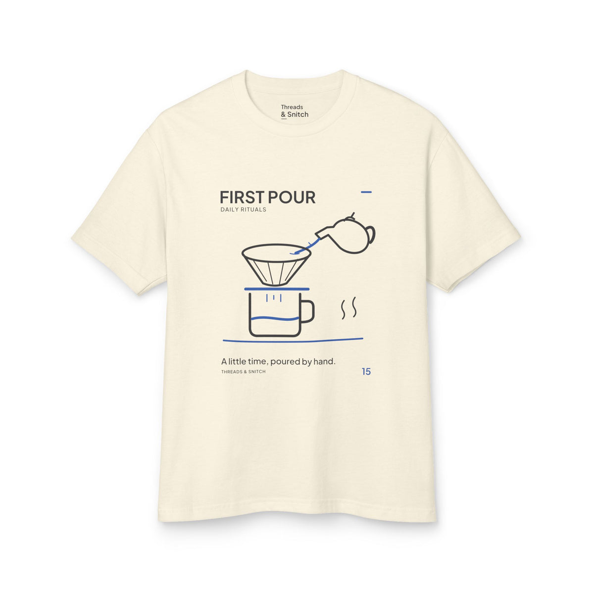 Mockup of First Pour Coffee Graphic Tee in Faded Cream, front view showing kettle pouring blue water into a coffee filter above a brew pot.