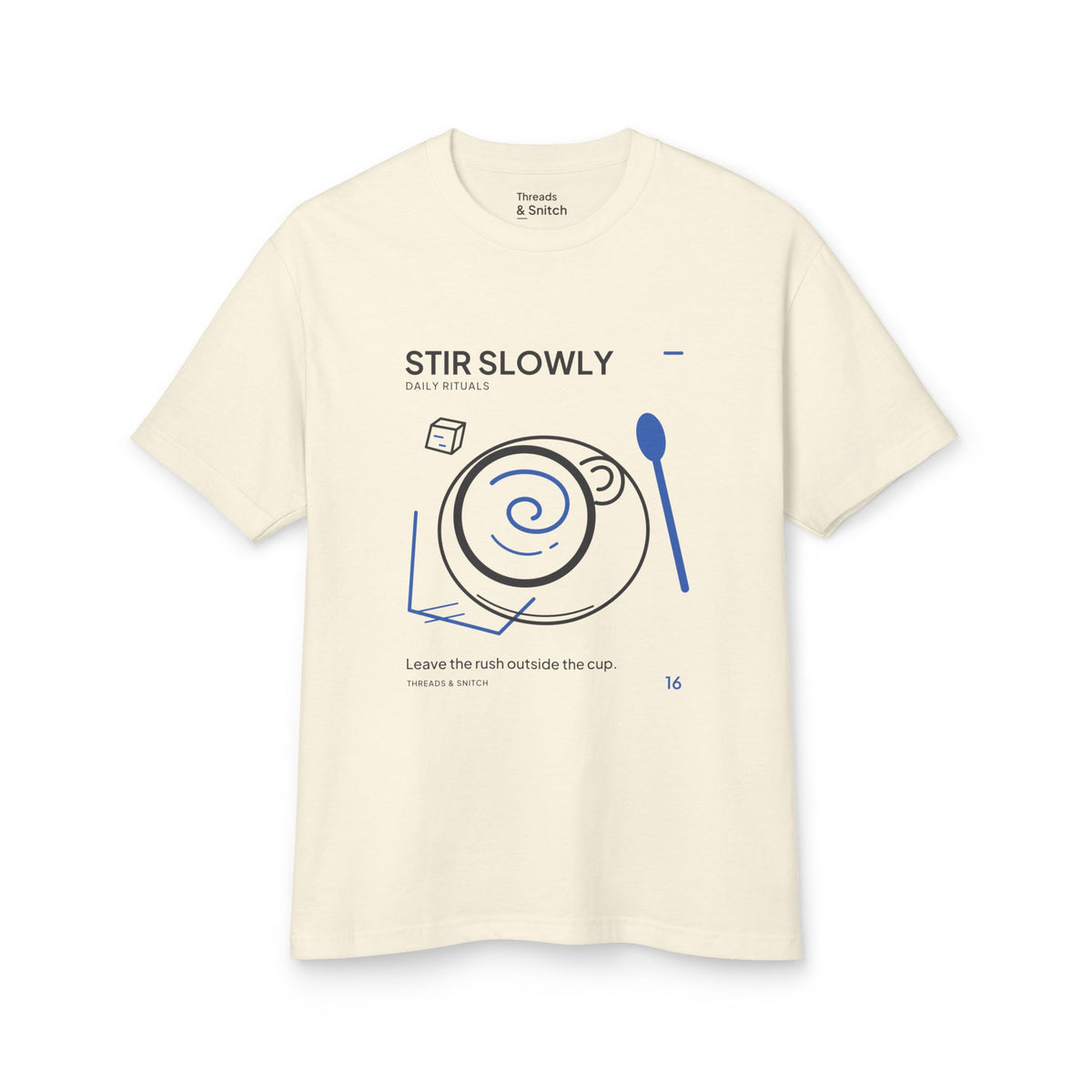 Mockup of Stir Slowly Cup & Spoon Tee in Faded Cream, front view showing cup and saucer with blue stirring spiral and oversized spoon.