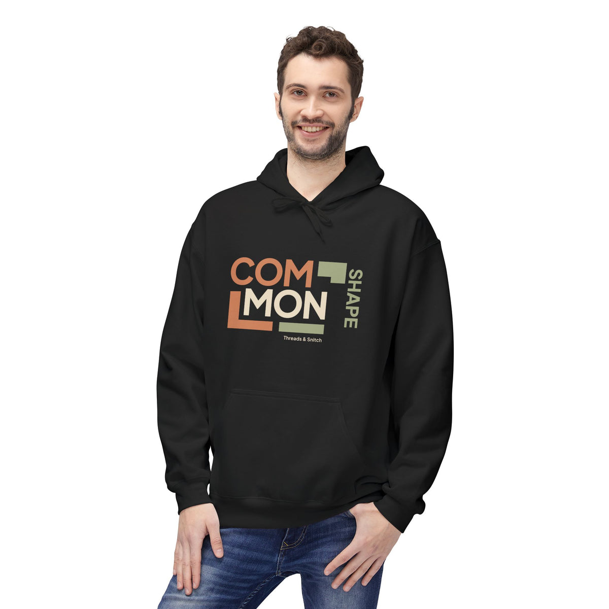 Model mockup of Common Shape Typography Hoodie in Black, front view showing stacked Common lettering, vertical Shape lettering and stepped blocks.