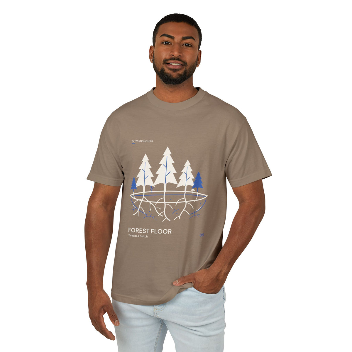 Model mockup of Forest Floor Botanical Tee in Faded Brown, front view showing five trees above exposed roots and a blue underground network.
