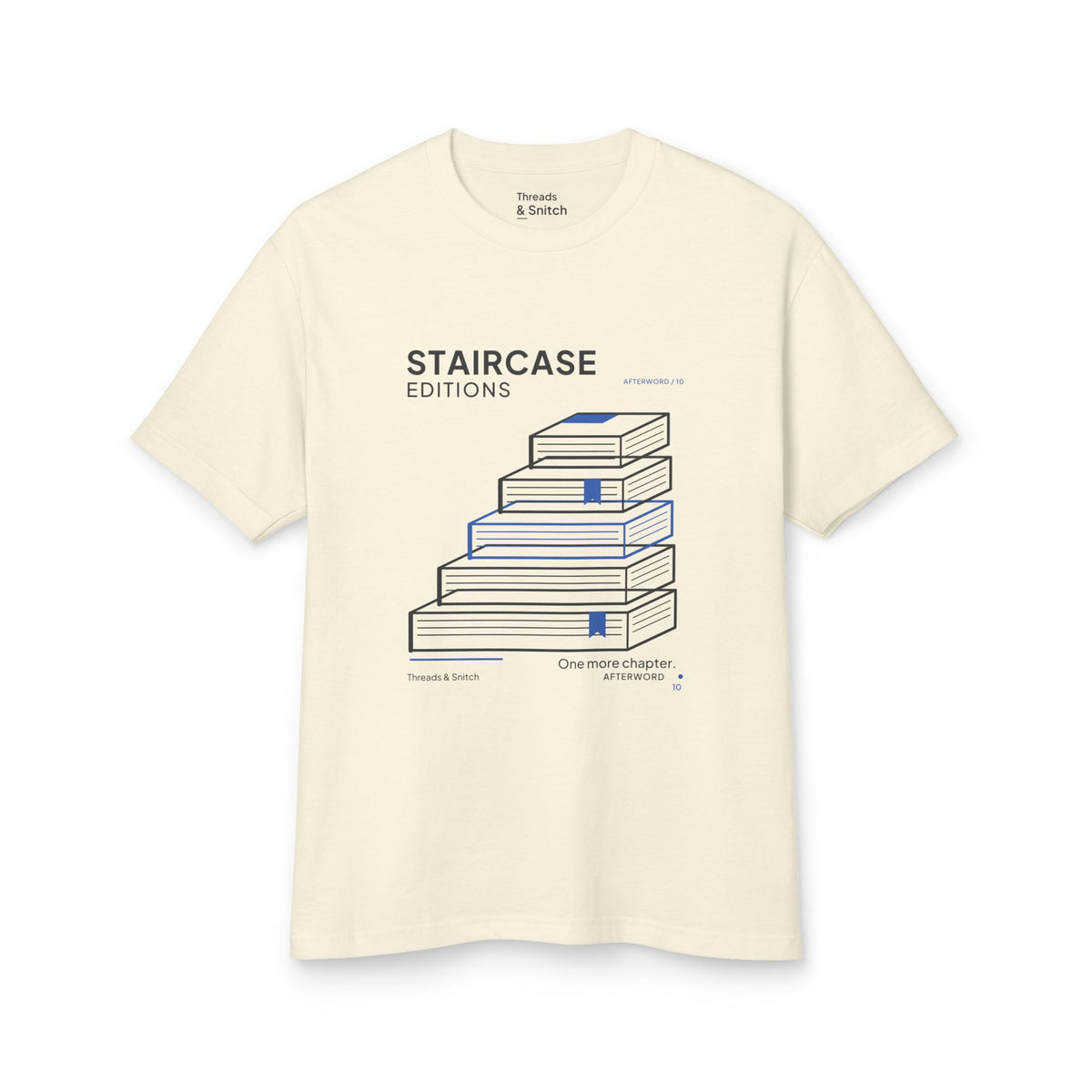 Mockup of Staircase Editions Book Stack Tee in Faded Cream, front view showing five staggered books forming stairs with blue bookmarks.