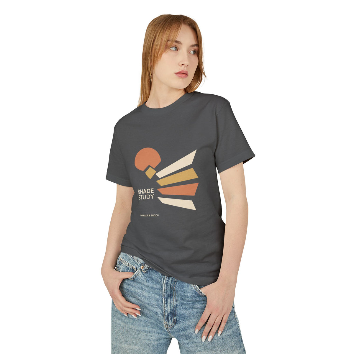 Model mockup of Shade Study Geometric Graphic Tee in Faded Black, front view showing a cut circular shape and radiating angular planes with Shade Study lettering.