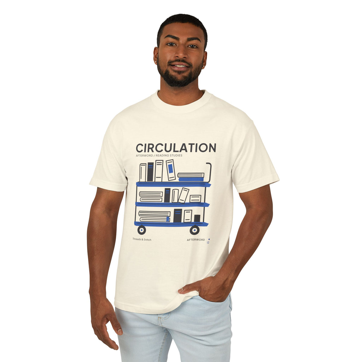 Model mockup of Circulation Library Cart Tee in Faded Cream, front view showing three-tier library cart filled with books and blue shelves.