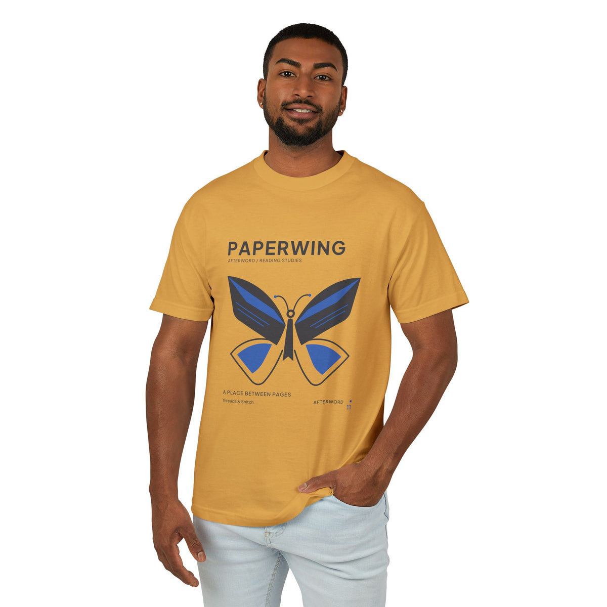 Model mockup of Paperwing Bookish Moth Tee in Faded Mustard, front view showing moth formed from folded-paper wings and a bookmark-like body.