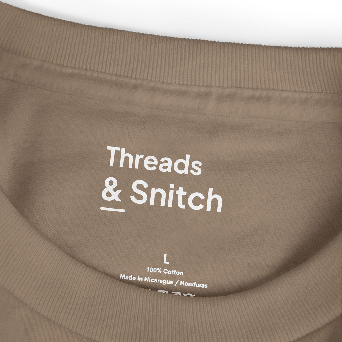 Mockup detail of the printed Threads & Snitch inner-neck label on Open Room Architectural Graphic Tee in Faded Brown.