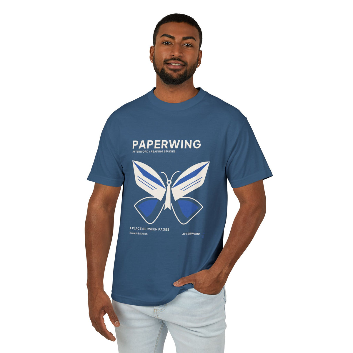 Model mockup of Paperwing Bookish Moth Tee in Faded Navy, front view showing moth formed from folded-paper wings and a bookmark-like body.