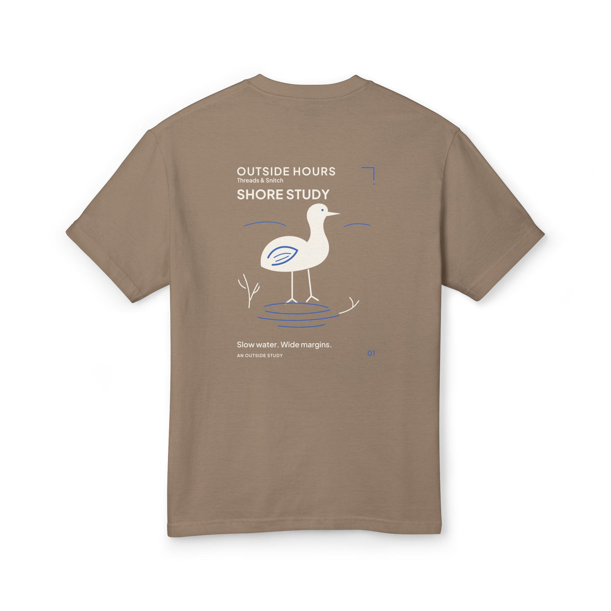 Mockup of Shore Study Bird Graphic Tee in Faded Brown, back view showing wading bird, reeds and blue water ripples.
