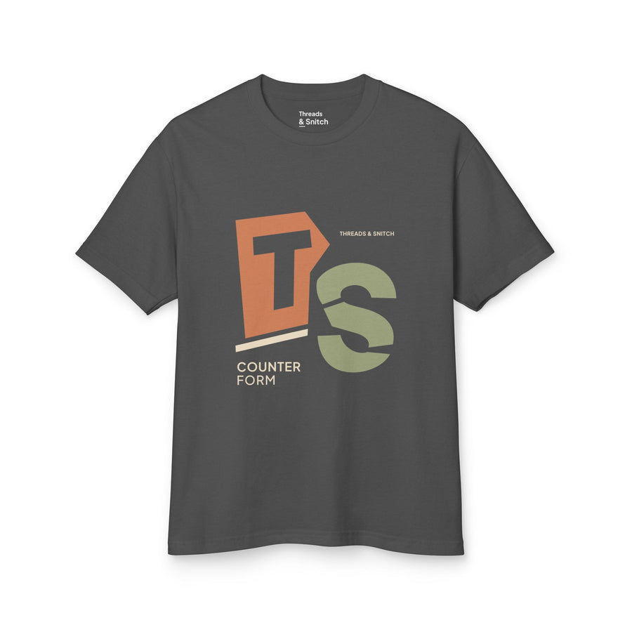 Mockup of Counterform Abstract Letter Graphic Tee in Faded Black, front view showing abstract T and S letterforms with Counterform lettering.