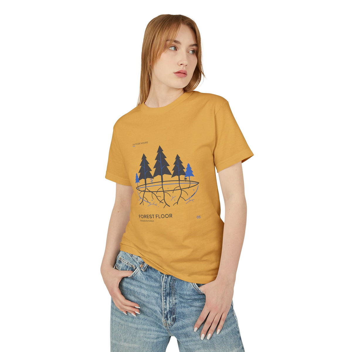 Model mockup of Forest Floor Botanical Tee in Faded Mustard, front view showing five trees above exposed roots and a blue underground network.