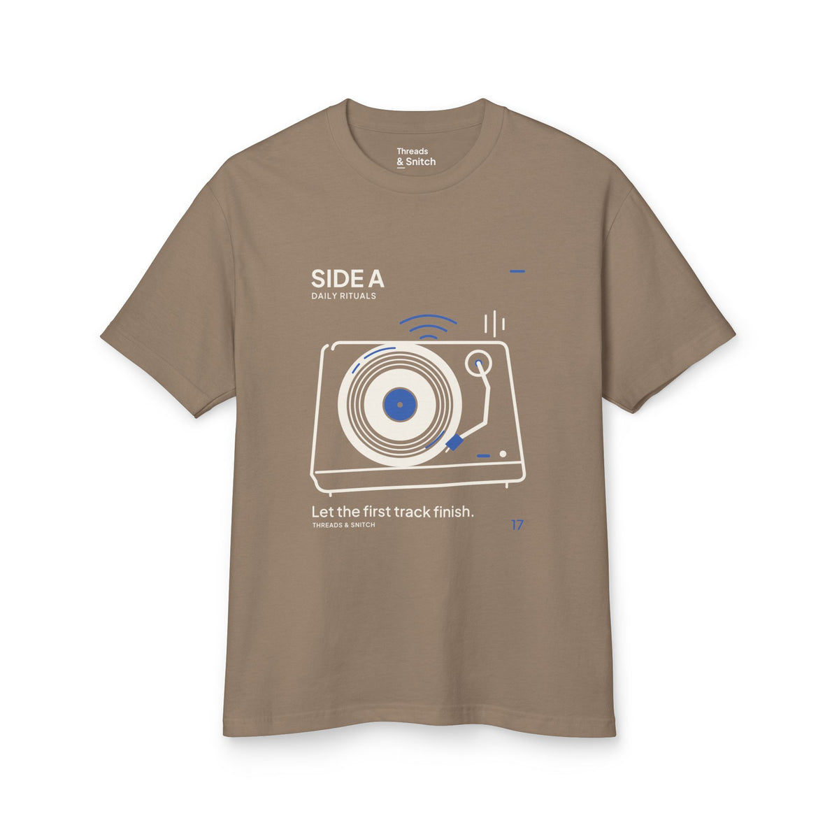 Mockup of Side A Record Player Tee in Faded Brown, front view showing record player with open circular grooves, tonearm and blue sound marks.