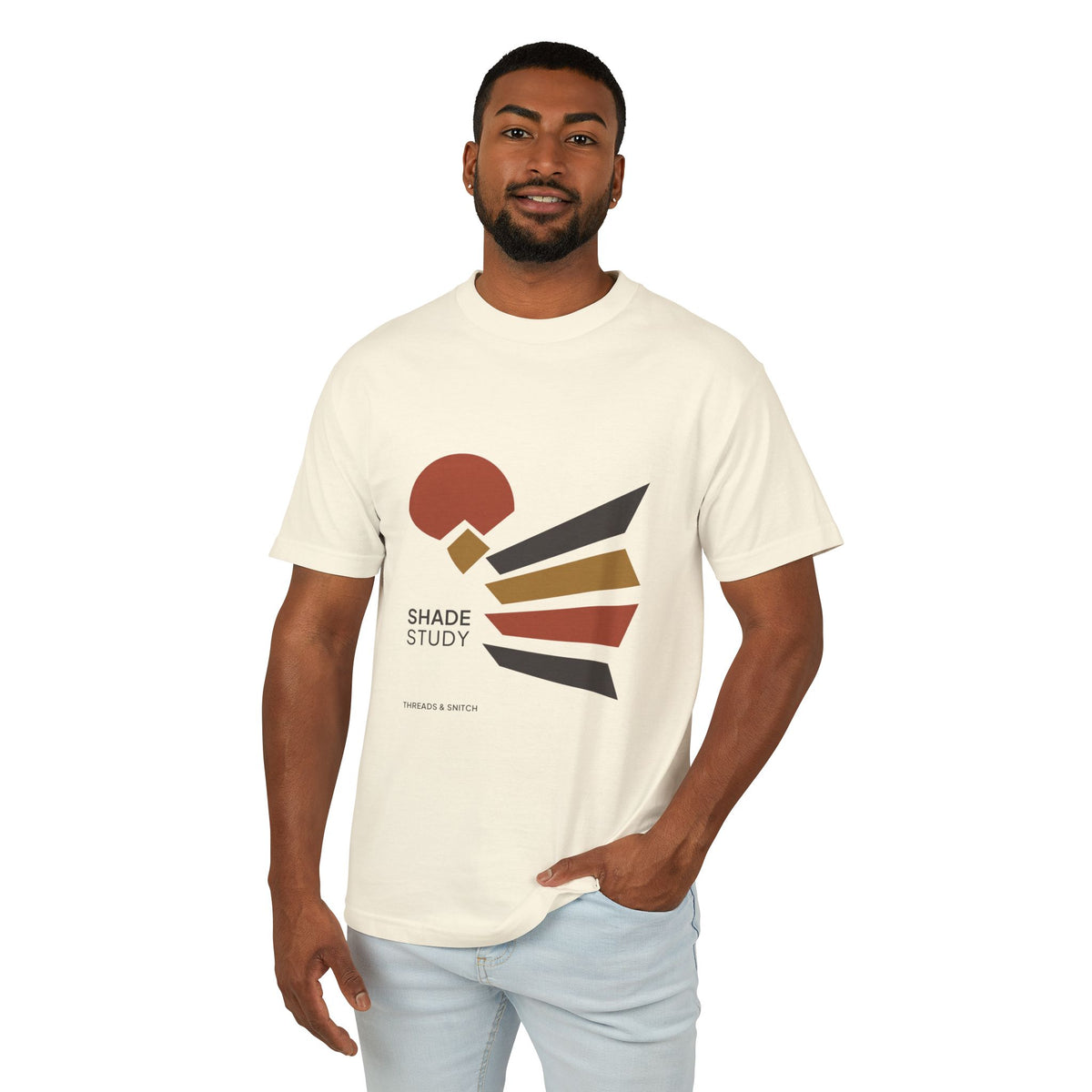 Model mockup of Shade Study Geometric Graphic Tee in Faded Cream, front view showing a cut circular shape and radiating angular planes with Shade Study lettering.
